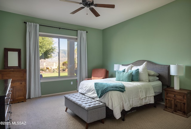 bedroom with light carpet, ceiling fan, and baseboards