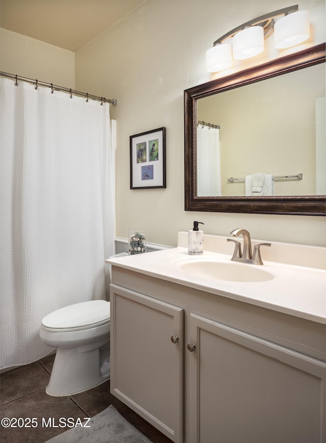 bathroom featuring toilet, vanity, and tile patterned floors