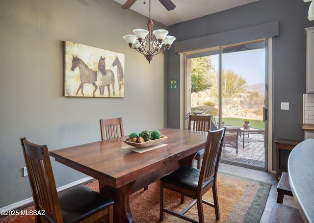 dining space with lofted ceiling, light tile patterned floors, and a chandelier