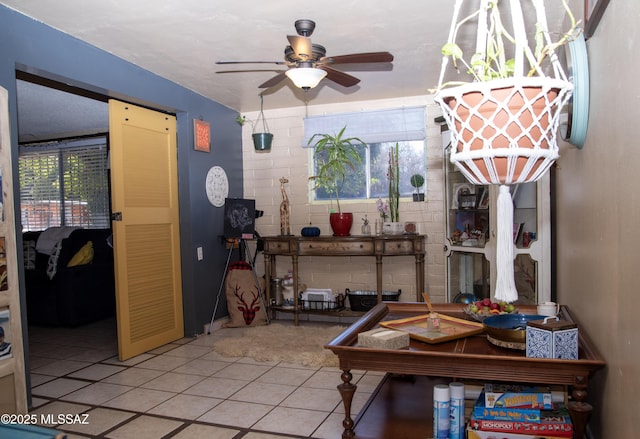 interior space featuring light tile patterned floors and a ceiling fan