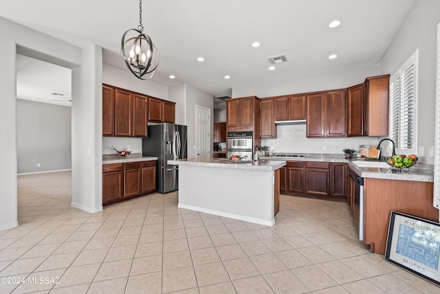 kitchen featuring light tile patterned flooring, a kitchen island with sink, recessed lighting, a sink, and appliances with stainless steel finishes