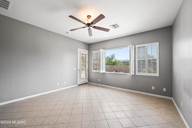 unfurnished room with ceiling fan, visible vents, and baseboards