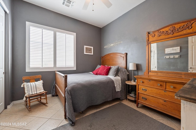 bedroom featuring ceiling fan, visible vents, baseboards, and light tile patterned flooring