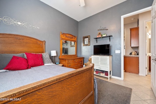 bedroom with baseboards, vaulted ceiling, a ceiling fan, and light tile patterned flooring