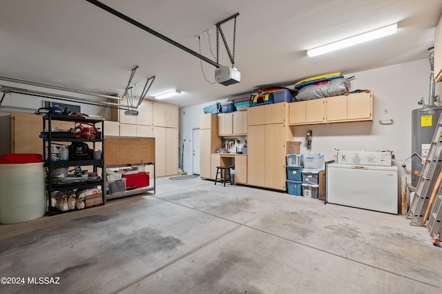 garage featuring water heater, washer / clothes dryer, and a garage door opener