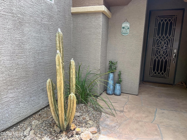 entrance to property with stucco siding