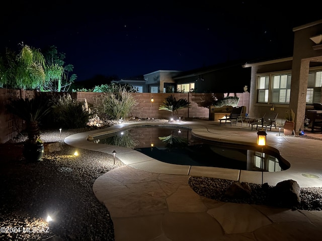 pool at twilight with a fenced in pool, a patio area, and a fenced backyard