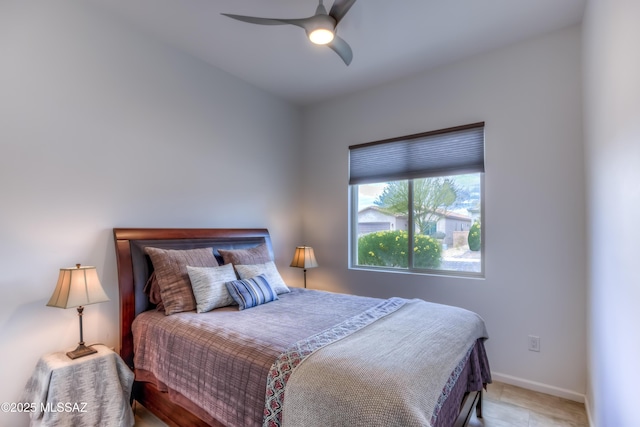 bedroom featuring a ceiling fan and baseboards