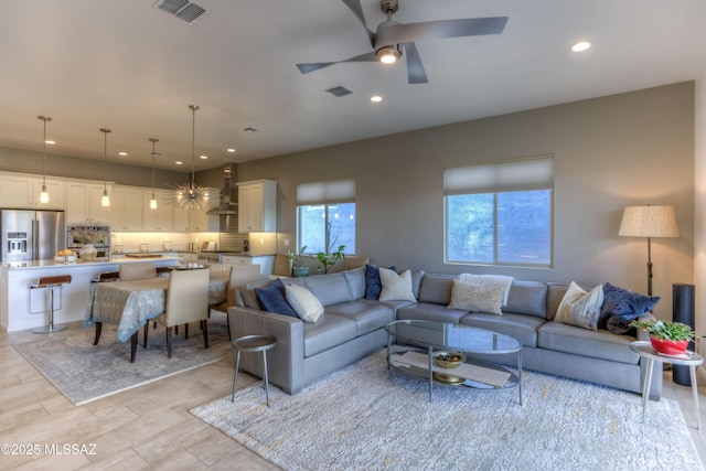 living room with recessed lighting, a ceiling fan, and visible vents