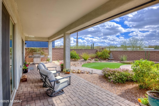 view of patio featuring area for grilling and a fenced backyard