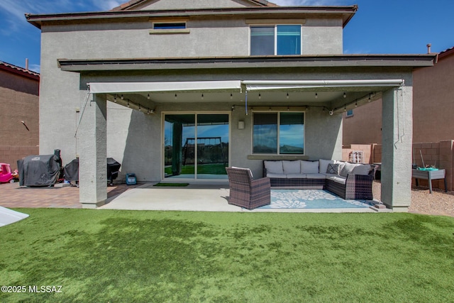 rear view of property featuring a patio area, an outdoor hangout area, and stucco siding