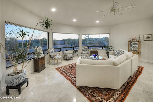 living area featuring a ceiling fan, recessed lighting, and baseboards