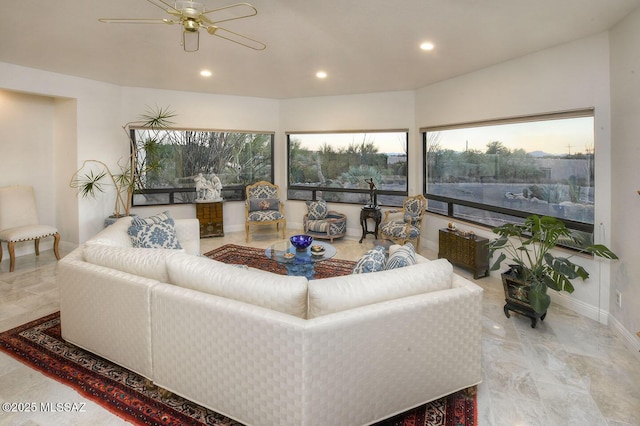 living area with recessed lighting, ceiling fan, and baseboards