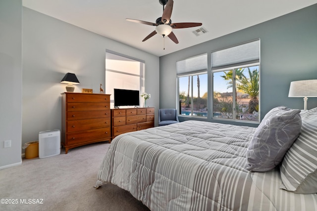 carpeted bedroom featuring visible vents and ceiling fan