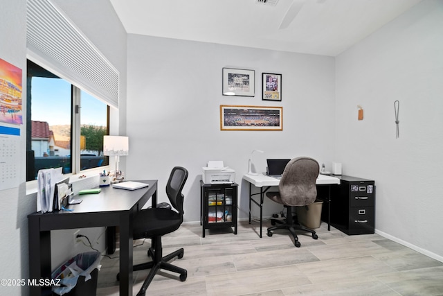 office area featuring light wood finished floors and baseboards