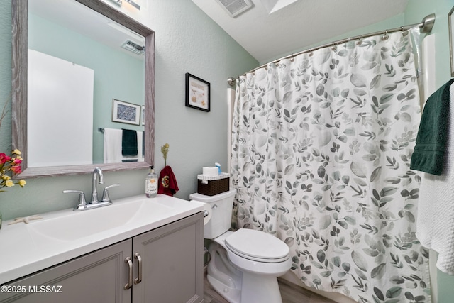 bathroom featuring toilet, a shower with curtain, visible vents, and vanity