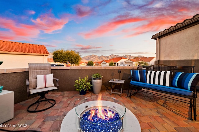 view of patio featuring a fire pit and a mountain view