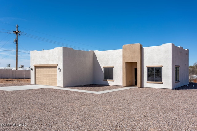 15809 N Twin Lakes Dr NW, Tucson, AZ 85739 - pueblo-style home featuring fence, driveway, stucco siding, and a garage