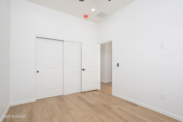 15809 N Twin Lakes Dr NW, Tucson, AZ 85739 - unfurnished bedroom with a closet, visible vents, light wood finished floors, baseboards, and recessed lighting