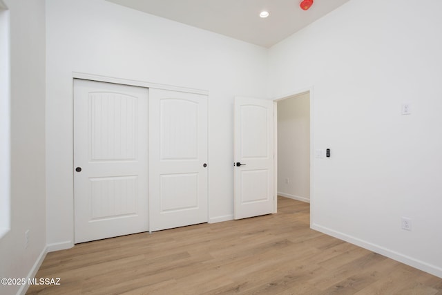 15809 N Twin Lakes Dr NW, Tucson, AZ 85739 - unfurnished bedroom featuring baseboards, a closet, light wood-style floors, and recessed lighting