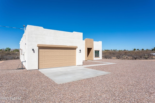 15809 N Twin Lakes Dr NW, Tucson, AZ 85739 - pueblo revival-style home with stucco siding, driveway, and a garage