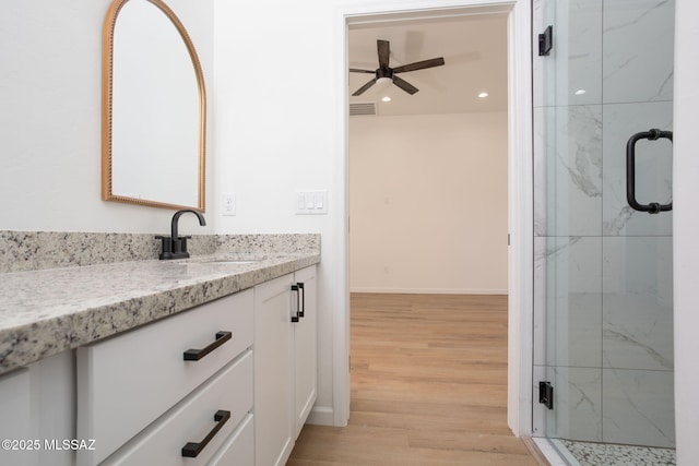 15809 N Twin Lakes Dr NW, Tucson, AZ 85739 - full bath featuring vanity, a marble finish shower, baseboards, a ceiling fan, and wood finished floors