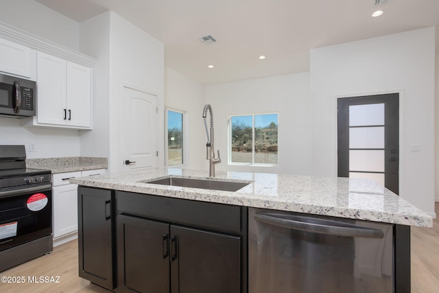 15809 N Twin Lakes Dr NW, Tucson, AZ 85739 - kitchen with light wood-style floors, a sink, white cabinetry, dishwasher, and electric range