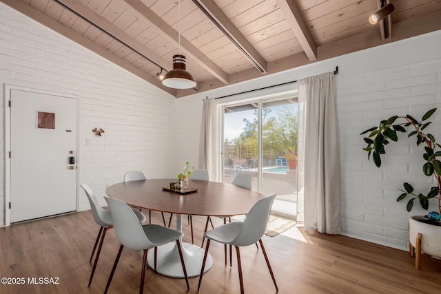 dining area with vaulted ceiling with beams, wooden ceiling, and light wood-style floors