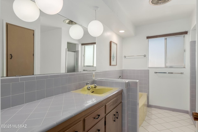 bathroom featuring a bath, tile patterned flooring, vanity, and baseboards