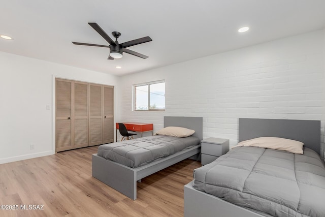 bedroom featuring baseboards, ceiling fan, light wood-type flooring, a closet, and recessed lighting