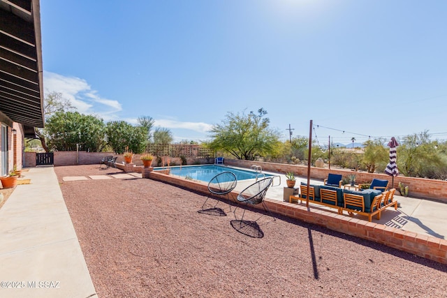 view of swimming pool with a patio area, a fenced backyard, an outdoor living space, and a fenced in pool