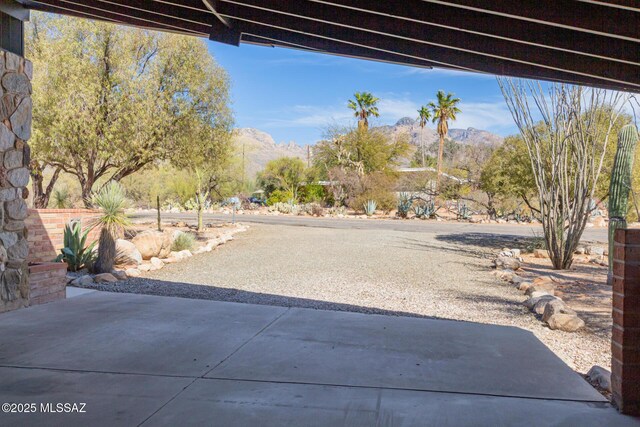 view of front of home featuring a patio area and brick siding