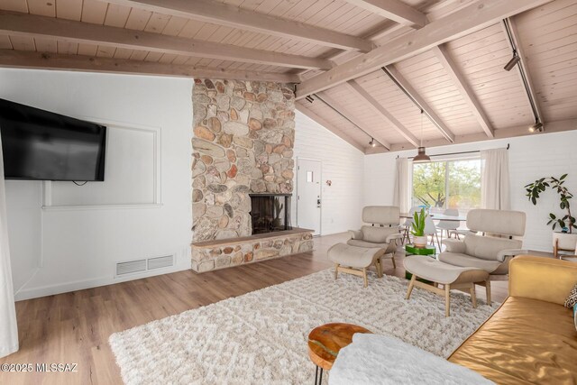 living room with wooden ceiling, visible vents, beamed ceiling, and light wood finished floors