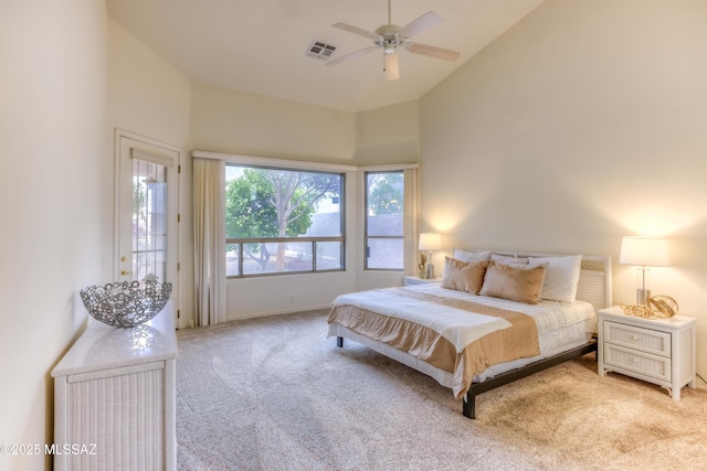 carpeted bedroom with visible vents, high vaulted ceiling, and ceiling fan