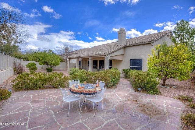 view of patio featuring outdoor dining area and a fenced backyard