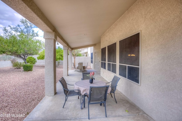 view of patio / terrace with outdoor dining space and fence