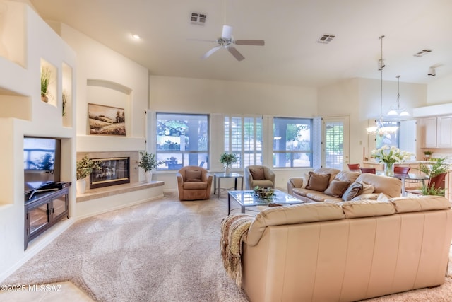 carpeted living area featuring visible vents, a healthy amount of sunlight, and a ceiling fan