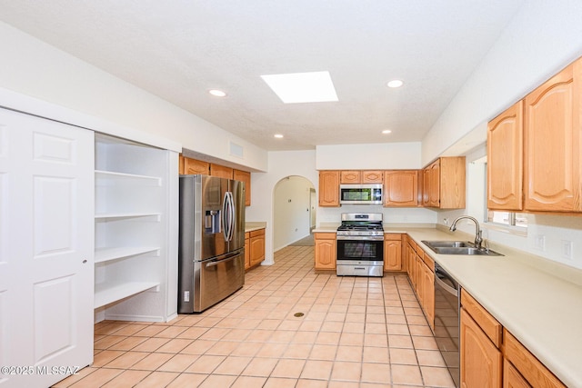 kitchen featuring recessed lighting, appliances with stainless steel finishes, a sink, and light countertops