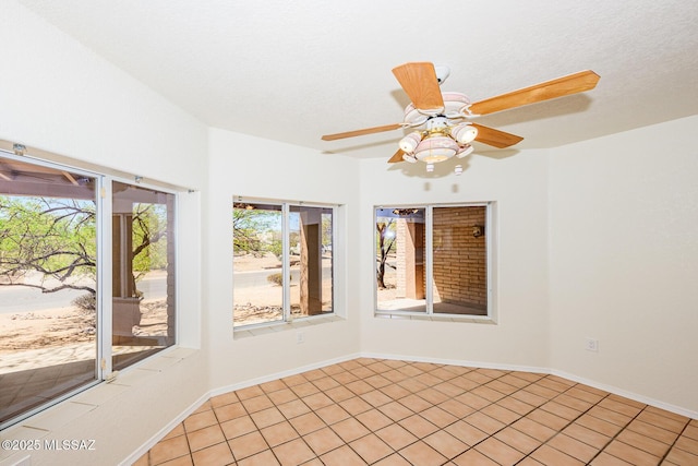 unfurnished room featuring baseboards and ceiling fan