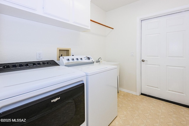 laundry room with cabinet space, washing machine and clothes dryer, and baseboards