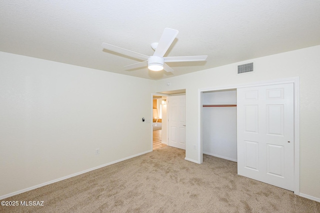 unfurnished bedroom with a ceiling fan, a closet, carpet floors, baseboards, and visible vents