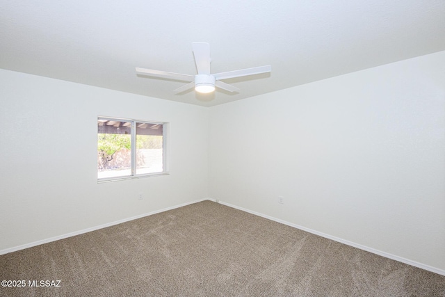 empty room featuring carpet, a ceiling fan, and baseboards