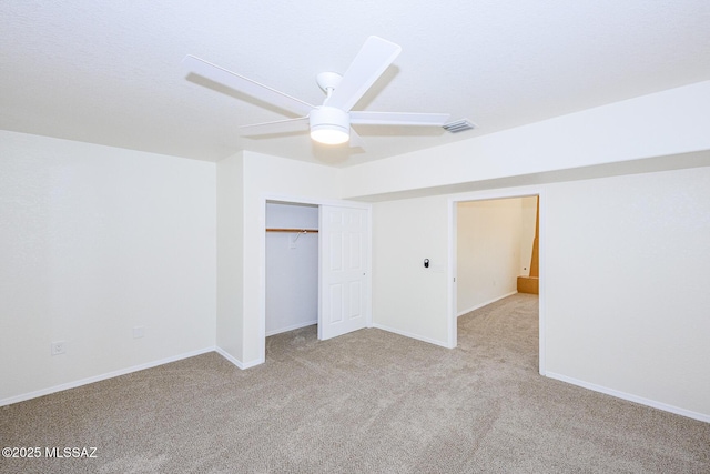 unfurnished bedroom with baseboards, carpet flooring, visible vents, and a closet