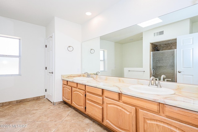 full bathroom with double vanity, a sink, visible vents, and a stall shower
