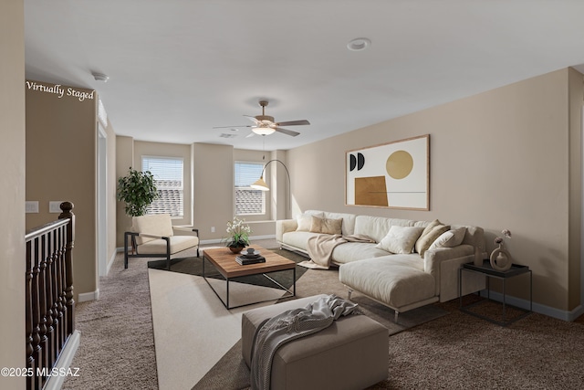 living area with carpet floors, a ceiling fan, and baseboards