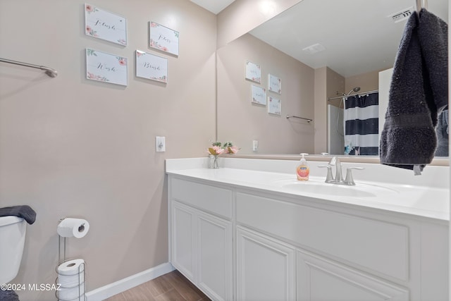 full bathroom with wood finished floors, visible vents, vanity, baseboards, and a shower with curtain