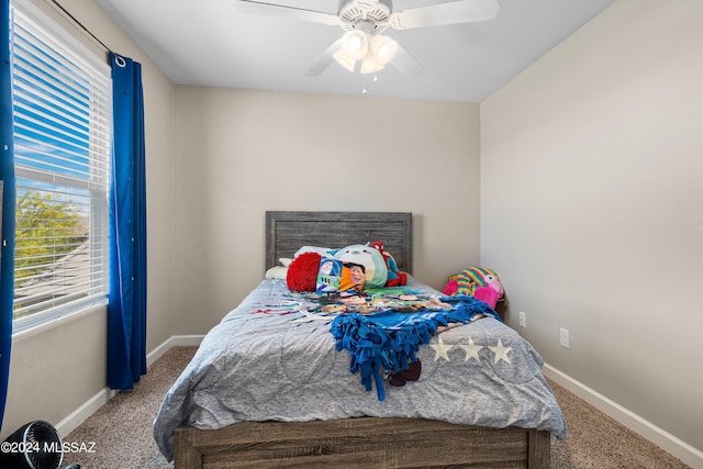 carpeted bedroom with a ceiling fan and baseboards