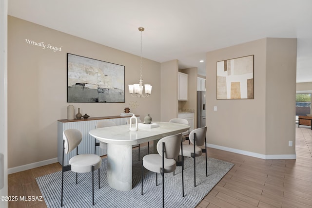 dining area with baseboards, recessed lighting, a chandelier, and light wood-style floors