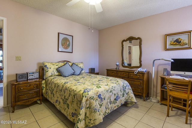 bedroom with a textured ceiling, ceiling fan, and light tile patterned flooring