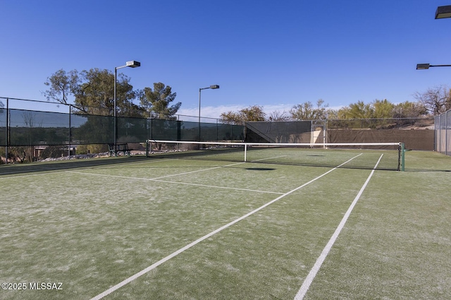 view of tennis court with fence